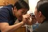 800px-US_Navy_040113-N-4614W-005_Capt._Wan_Mun_Chin_examines_a_patient_suffering_from_a_sore_throat_and_high_fever