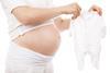 Pregnant_woman_holds_white_babygrow_sleeper