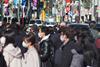 Crowd of people in street wearing protective masks