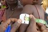 A_child_is_checked_for_signs_of_malnutrition_in_Katsina_State,_Nigeria,_March_2011_(8406367308)