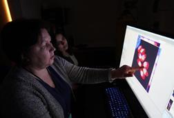 Low-Res_Elena Suvorova and Mrinalini Batra observing the detailed toxomplasma cells -- credit USF