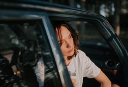 Depressed_woman_resting_in_car_during_golden_hour_near_forest