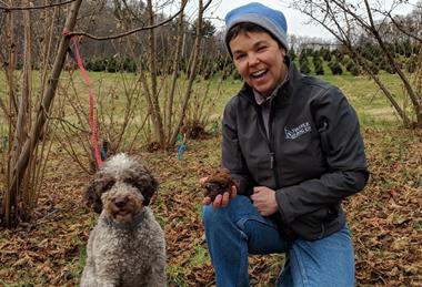 trainer in woods with dog