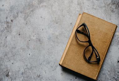 Old_glasses_on_old_book_from_above