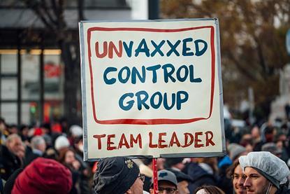 Protester_holding_sign_with_text__Unvaxxed_control_group._Team_leader_._Anti-vaccine_mandate_rally_in_Austria_(51692844747)