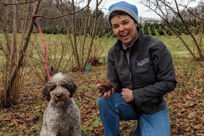 trainer in woods with dog