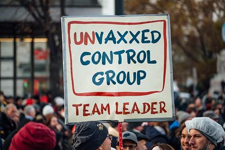 Protester_holding_sign_with_text__Unvaxxed_control_group._Team_leader_._Anti-vaccine_mandate_rally_in_Austria_(51692844747)