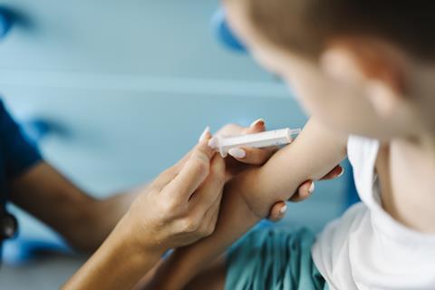 Child_receiving_a_vaccination_in_a_healthcare_setting_with_a_medical_professional_present