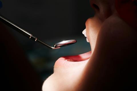 dentist investigating mouth